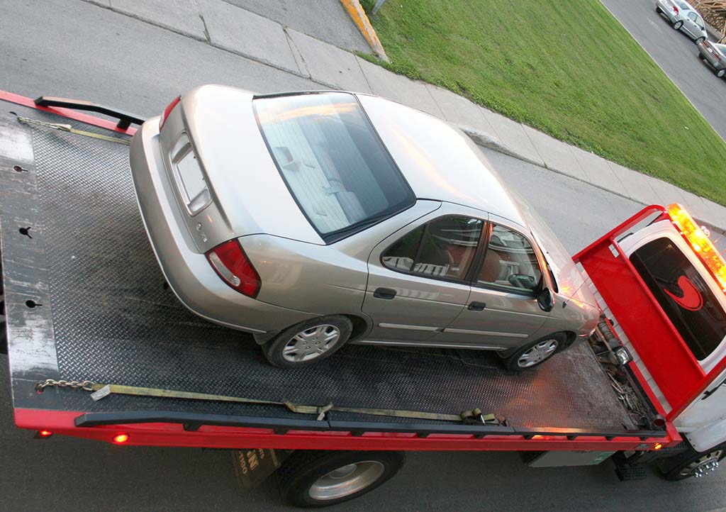 Silver car on tow truck